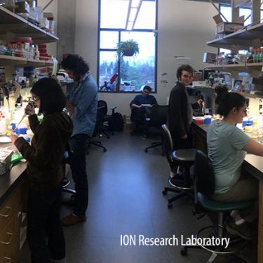 Several people working in a lab in L I S B. 