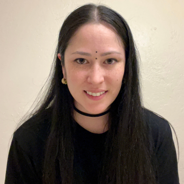Headshot of student in front of a blank beige background