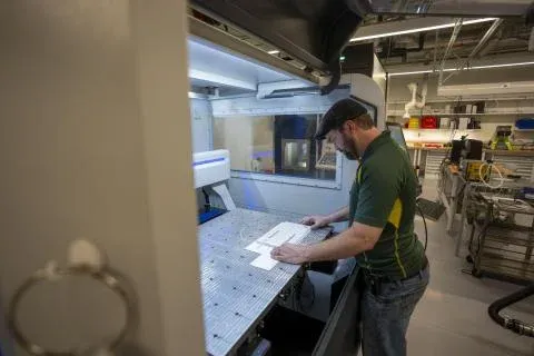 A person stands at a workbench in the Oregon Fabrication and Design facility.