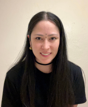 Headshot of student in front of a blank beige background