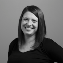 Black and white portrait of Dr. Marina Garrett smiling and looking directly at the camera