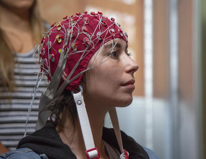 A student is fitted with an E E G cap.