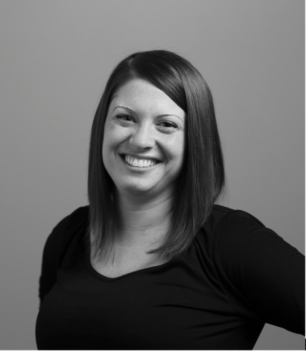 Black and white portrait of Dr. Marina Garrett smiling and looking directly at the camera