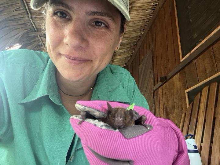 Photo of Dr. Angeles Salles, holding a bat
