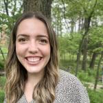 woman standing in front of greenery