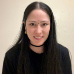 Headshot of student in front of a blank beige background